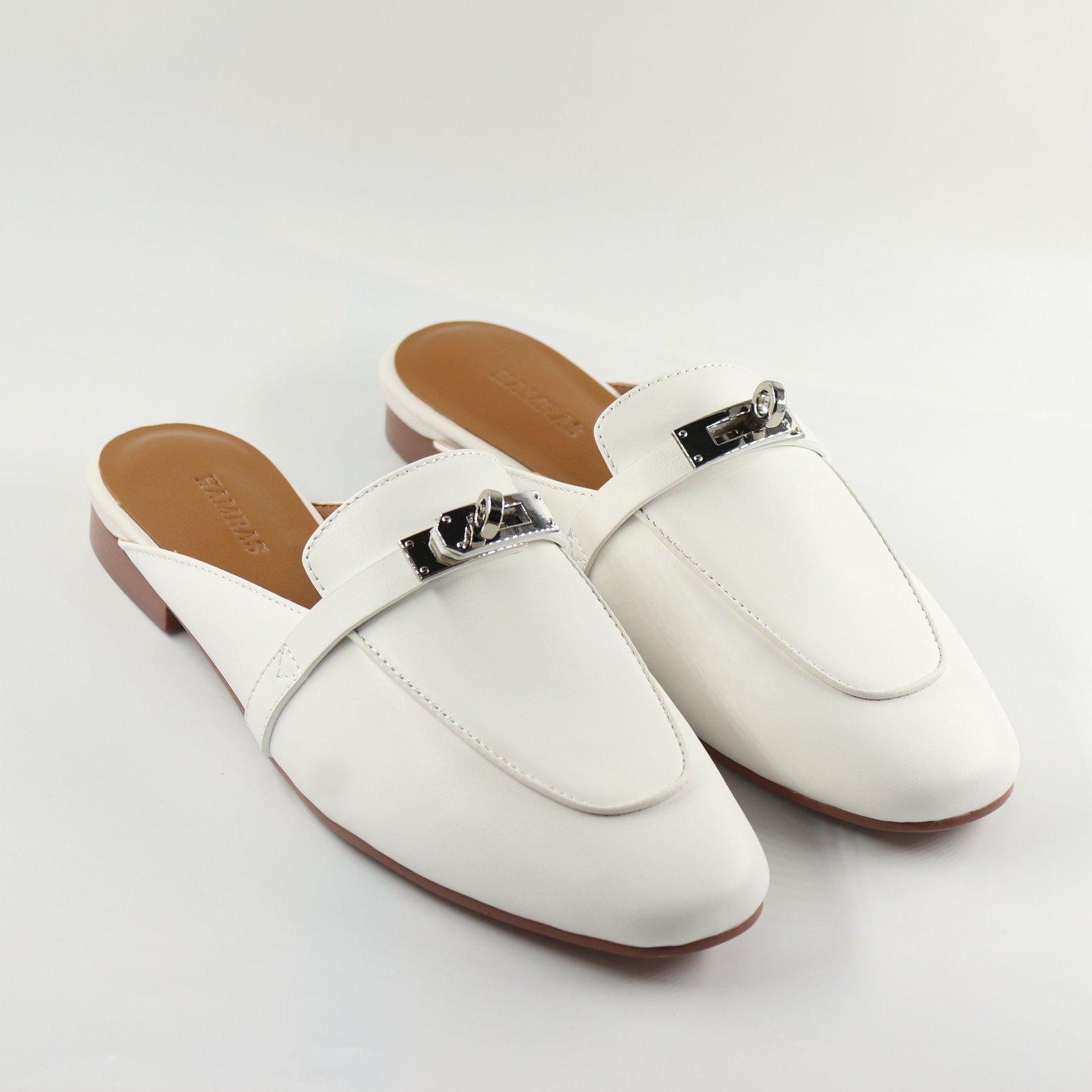 White slip-on loafers with metal buckle for women